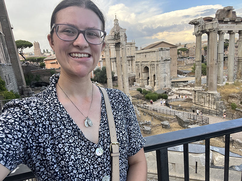 A student standing outside of the Roman Forum