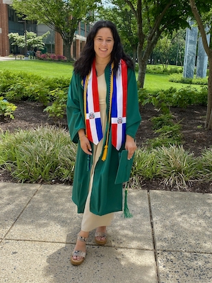 Amanda Pena wearing graduation regalia on Mason's Fairfax Campus.