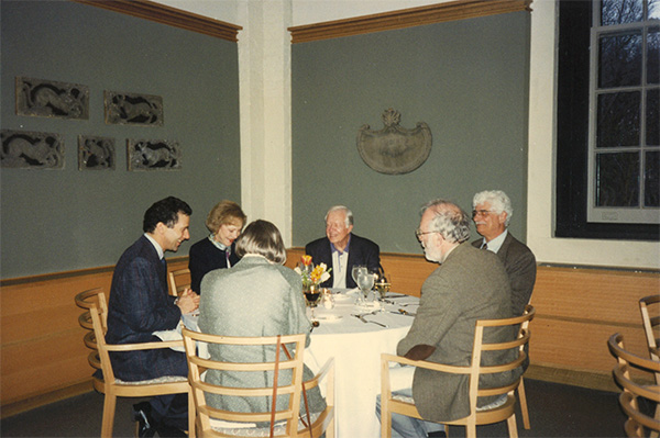 Photo of Chris Mitchell and colleagues seated for a meal with Jimmy and Rosalynn Carter.