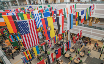 Flags from around the world hang above a student center cafeteria.