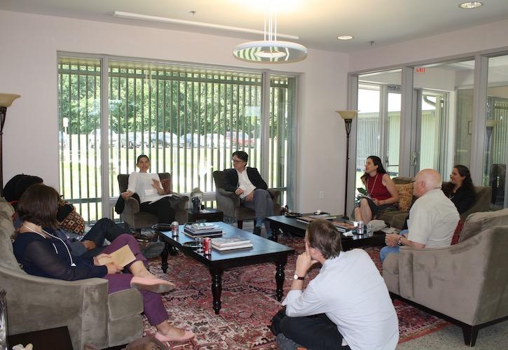 Workshop participants are gathered in a lounge on comfortable chairs and couches