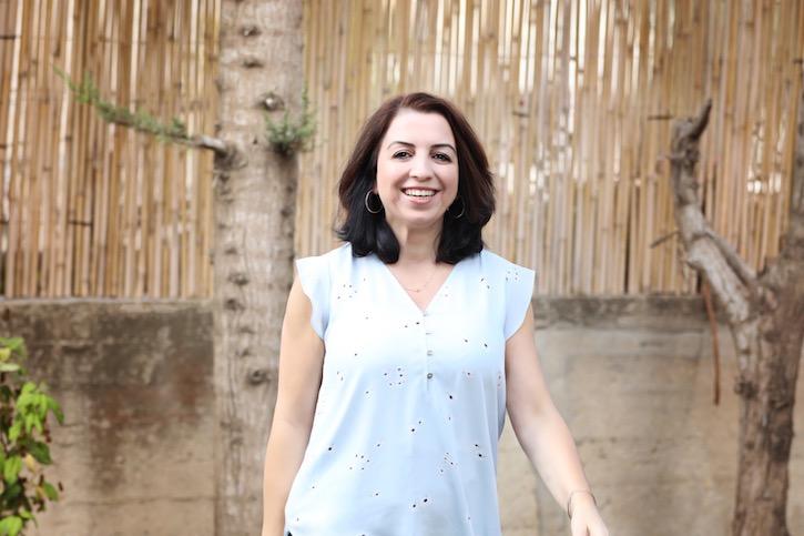 Photo of Fakhira Halloun, a Palestinian citizen of Israel, who is pictured in an outdoor setting.