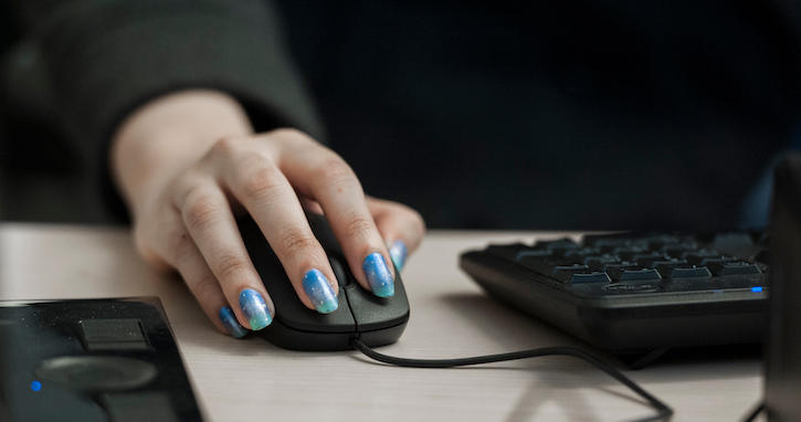 Photo of computer user's hand on a mouse