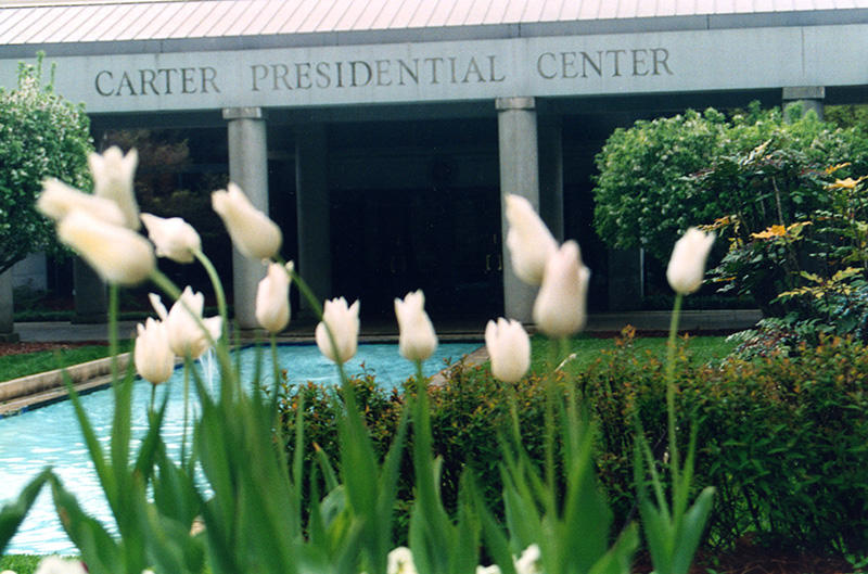 Flowers blooming in front of the entrance to the Carter Presidential Center.