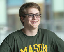 Photo of Nathaniel Socks smiling and wearing a Mason T-shirt
